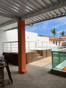 a patio with a view of a house at HOTEL ENSEADA BEIRA MAR in Guarujá