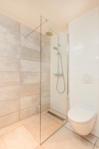 a bathroom with a glass shower with a toilet at Resort Bonaire in Kralendijk