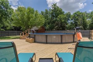 a patio with a swimming pool and a wooden deck at Peaceful and Relaxing Getaway w Beautiful Pool in Richardson