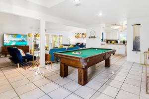 a living room with a pool table in it at Desert Pool House: Sun, Swim, Sip & Stay in Indio