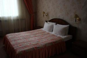 Säng eller sängar i ett rum på Volga Hotel