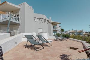 a row of chairs sitting on a patio at Placid Village in Carvoeiro