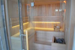 a sauna with a glass door and a shower at Relais San Desiderio in Calliano