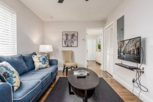 Una sala de estar con un sofá azul y una mesa. en The Guesthouse 1 - Wilton Manors, en Fort Lauderdale