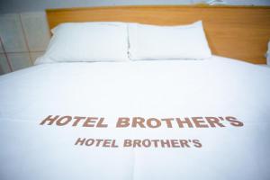 a bed with two white pillows and the words hotel brothers at Hotel Brothers São Paulo - 3km do Hospital das Clínicas FMUSP, proximo a Universidades - By UP Hotel in Sao Paulo