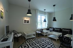 a living room with a couch and chairs and tables at Green Hill Guest House in Berkovitsa