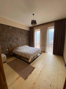 a bedroom with a bed and a wooden floor at DN House Dilijan in Dilijan