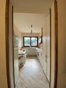a large kitchen with a large window and a table at DN House Dilijan in Dilijan
