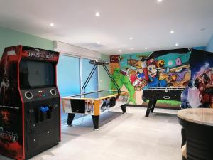 a room with a video game system and a ping pong table at Gîte de Brunemont in Diéval