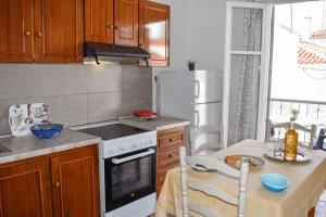 a kitchen with a table and a stove top oven at Skiathos home with the best view in Skiathos