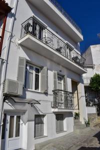 a white building with balconies on the side of it at Skiathos home with the best view in Skiathos