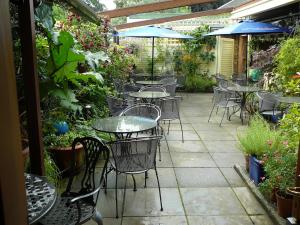 a patio area with tables, chairs and umbrellas at The Globe Inn in Lostwithiel