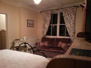 a living room filled with furniture and pillows at The Globe Inn in Lostwithiel