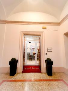 un pasillo con una alfombra roja en un edificio en Alius and Freerome Hotel, en Roma