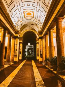 a hallway of a building with columns and a ceiling at Alius and Freerome Hotel in Rome