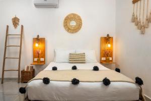 a bedroom with a large bed in a room at Verandah Studios in Playa del Carmen