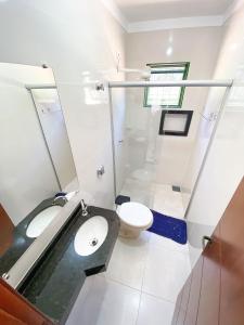 a bathroom with a sink and a toilet at Otimo apto c WiFi - Monte Castelo, Campo Grande MS in Campo Grande