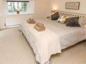 a bedroom with two beds with towels on them at Freemantle Lodge in Ventnor