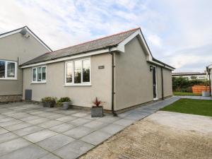 a detached house with a driveway in front of it at Cedars in Holyhead