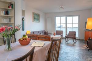 a living room with a table and a living room with a couch at Franze´s Haus - mit Rhein- & Burgenblick in Boppard