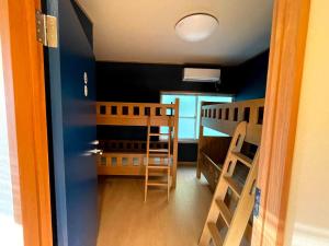 a small room with two bunk beds and a hallway at I,K,I HOUSE TSURUKIFURE - Vacation STAY 14773v in Iki