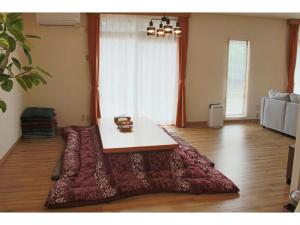 a living room with a table on a red rug at Glamp House DAISEN Garden - Vacation STAY 97255v in Yonago