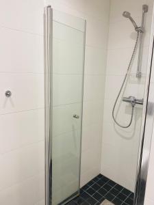 a shower with a glass door in a bathroom at Perfect Christmas atmosphere! Beautiful Apartment at Skagahøgdi with Panoramic View in Gol