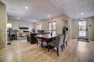 a dining room and living room with a table and chairs at WaterWalk San Antonio at The Rim in San Antonio