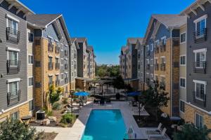 an aerial view of the courtyard of a apartment building with a swimming pool at WaterWalk San Antonio at The Rim in San Antonio