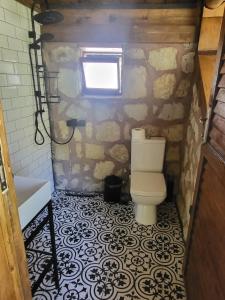 a bathroom with a toilet and a stone wall at Taş_suit in Kartepe