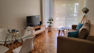 a living room with a couch and a tv at Mi corazon en San Telmo in Buenos Aires