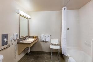 a bathroom with a sink and a shower and a tub at Handlery Hotel San Diego in San Diego