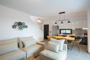 a living room with a couch and a table at SEASCAPE VILLAS VASSILIKI - Beachfront villas in Vasiliki