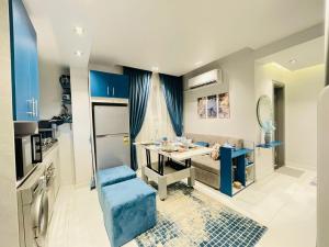 a kitchen with a table and a couch in a room at Luxury Studio House 589-2 in 6th Of October