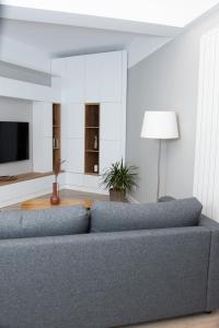 a living room with a couch and a television at Anise Apartment in Bucharest