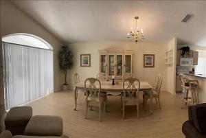 a dining room with a table and chairs at 34 Thousand House in Davenport