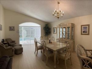 a dining room with a table and chairs and a living room at 34 Thousand House in Davenport