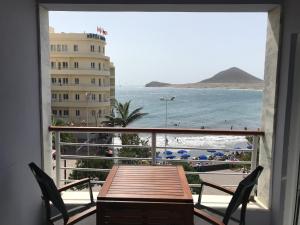a balcony with a table and chairs and a view of the ocean at Playa Grande, El Médano Best View in El Médano