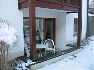 a porch of a house with a table and chairs at Ferienwohnung Lilli inklusive Bad Hindelang Plus in Bad Hindelang