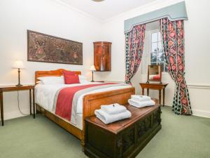 a bedroom with a bed with two towels on it at The Preston Tower Apartment - Fyvie Castle in Turriff