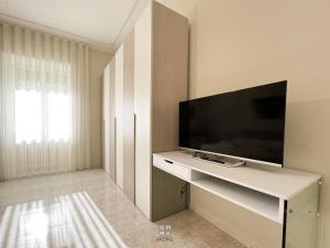 a living room with a flat screen tv on a wall at Emma Home Matera in Matera