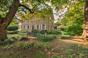 an old brick house with a bench in front of it at Beautiful Historic House In Amish Country in Ephrata