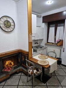 a kitchen with a table and a fire place at Lo sciuro in Busto Arsizio