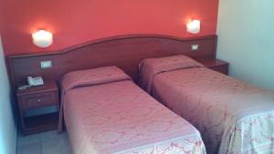 Postel nebo postele na pokoji v ubytování Hotel Giardino