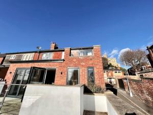 a red brick building with a staircase in front of it at Stylish 3 bed house with Castle views in Lincolnshire