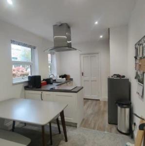 a kitchen with a table and a refrigerator in it at LetAway - Yonge's Place Saltburn in Saltburn-by-the-Sea