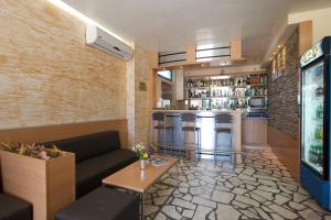 a living room with a couch and a bar at Paloma - in the center of the city in Sunny Beach