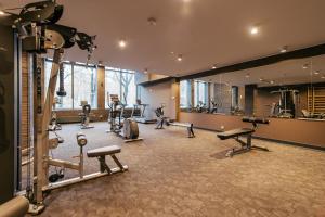 a gym with several treadmills and machines in a room at Klif Apartamenty Nadmorskie Tarasy C403 in Kołobrzeg