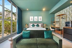 um quarto com uma cama e um sofá em Don Rafa Boutique Hotel & Residences em San Juan