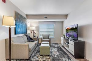 a living room with a couch and a tv at Parks Residential Denver in Centennial